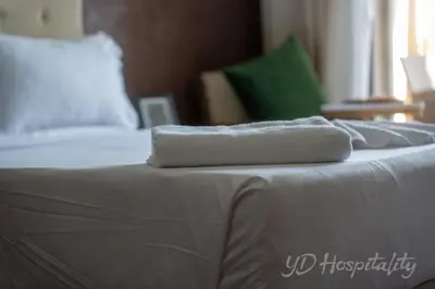 a white towel sitting on top of a bed at 5-Star Suite in Prime Spot with Luxe Touches in Marrakech