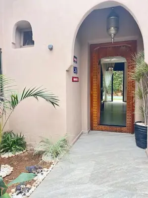 a hallway of a building with a door with a mirror at Villa M à Marrakech in Marrakech