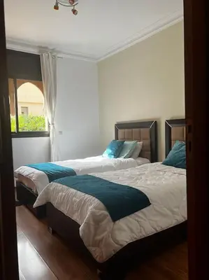 two beds sitting next to each other in a bedroom at Villa M à Marrakech in Marrakech