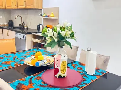 a vase of flowers on a table in a kitchen at Villa M à Marrakech in Marrakech