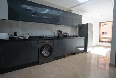 a kitchen with a washing machine in the middle at Appartement au cœur de Marrakech in Marrakech