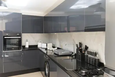 a kitchen with black cabinets and a stove at Appartement au cœur de Marrakech in Marrakech