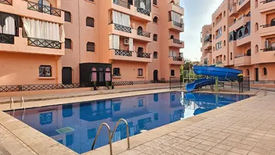 a swimming pool with a slide in front of some buildings at Amazing view, apartment in Marrakech in Marrakech