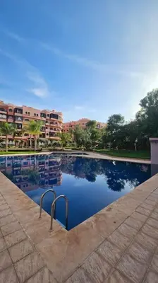a large pool of water with buildings in the background at Amazing view, apartment in Marrakech in Marrakech