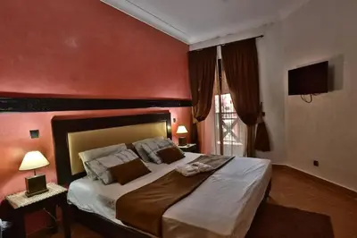 a bedroom with a large bed with a red wall at Amazing view, apartment in Marrakech in Marrakech