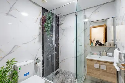 a bathroom with a shower and a sink at Charm Apt dans le triangle Tourisme de Marrakech ! in Marrakech