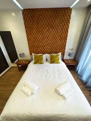 a bedroom with a large white bed with two pillows at Appart au Cœur de Gueliz in Marrakech