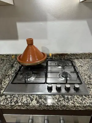 a tea pot sitting on top of a stove at calme est spacieux 37 pour les familles in Marrakech