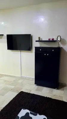a living room with a flat screen tv on a wall at calme est spacieux 37 pour les familles in Marrakech