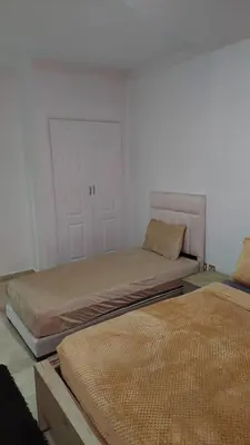 a room with two beds in a room at calme est spacieux 37 pour les familles in Marrakech