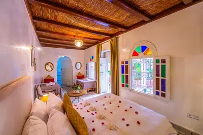 a living room with a white couch and a window at Riad LAMDINA in Marrakech