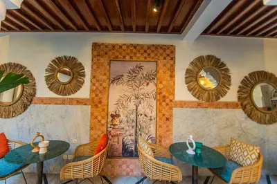 a restaurant with two tables and chairs and mirrors at Riad LAMDINA in Marrakech