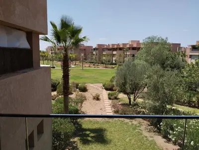 a view of a garden from a balcony of a building at Appartement de luxe Prestigia in Marrakech