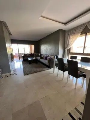 a living room with a couch and a table and chairs at Appartement de luxe Prestigia in Marrakech