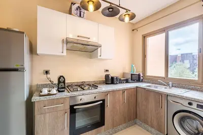 a kitchen with a sink and a dishwasher at Stunning Prestigia Escape Poolside Views in Marrakech