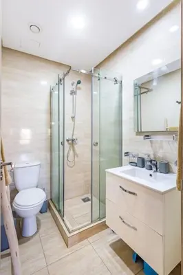 a bathroom with a shower and a toilet and a sink at Stunning Prestigia Escape Poolside Views in Marrakech