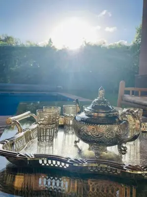 a table with a tea pot and glasses on it at Villa avec piscine chauffée en option Palmeraie in Marrakech