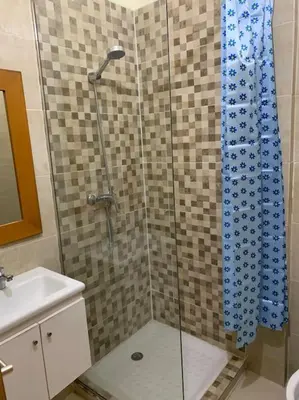 a shower with a glass door in a bathroom at Appartement Moderne bien équipée reservation Juste pour les familles est les couples mariés in Marrakech