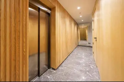 a hallway with wooden walls and a hallway with a corridorngthngthngthngthngth at Élégance urbaine, Gueliz central in Marrakech