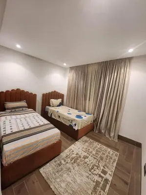 a bedroom with two beds and a window at Élégance urbaine, Gueliz central in Marrakech