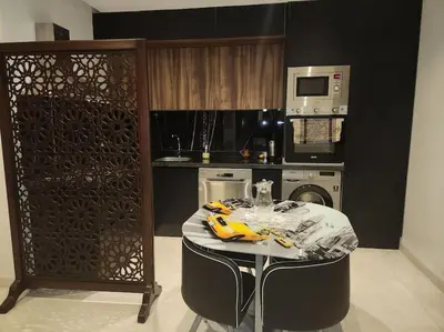 a kitchen with a table and a microwave at Élégance urbaine, Gueliz central in Marrakech
