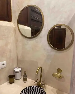 a bathroom with a sink and two mirrors at Riad Dar Fannan en exclusivité in Marrakech
