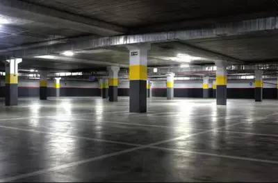 an empty parking lot with columns in a parking garage at appartement Nizar in Marrakech