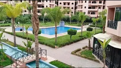 an aerial view of a swimming pool in a resort at appartement Nizar in Marrakech