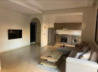 a living room with a couch and a coffee table at appartement Nizar in Marrakech