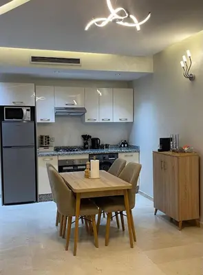 a kitchen with a table and chairs in a kitchen at Chambre de luxe avec piscine in Marrakech