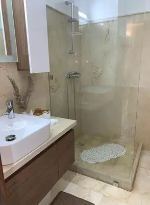 a bathroom with a shower and a sink and a sink at Chambre de luxe avec piscine in Marrakech