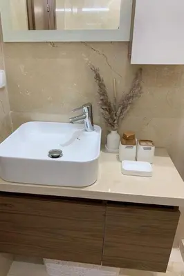 a white bathroom sink sitting on top of a counter at Chambre de luxe avec piscine in Marrakech