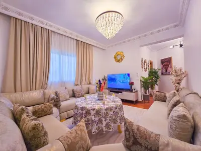 a living room with a couch and a table at Luxoria Home - Pool & 3 min To Gueliz in Marrakech