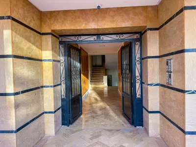 an empty hallway of a building with blue doors at Luxoria Home - Pool & 3 min To Gueliz in Marrakech