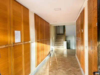 a hallway with wood paneled walls and a staircase at Luxoria Home - Pool & 3 min To Gueliz in Marrakech