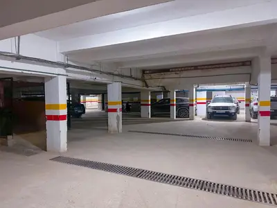 an empty parking garage with cars parked in it at Luxoria Home - Pool & 3 min To Gueliz in Marrakech