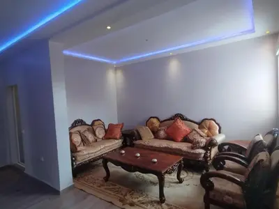 a living room with couches and a coffee table at Appartement au centre Marrakech in Marrakech