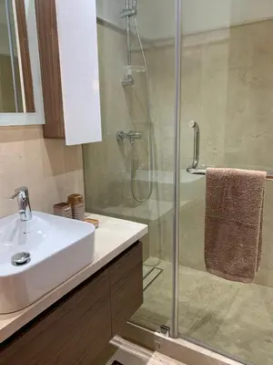 a bathroom with a sink and a glass shower at Appartement luxueux marrakech in Marrakech