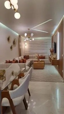 a living room with a couch and a table and chairs at Appartement luxueux marrakech in Marrakech