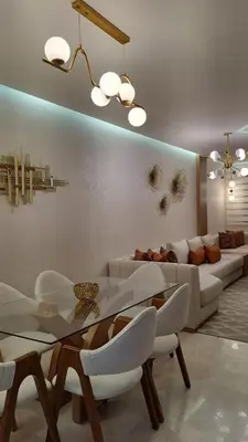 a living room with a couch and a table and chairs at Appartement luxueux marrakech in Marrakech