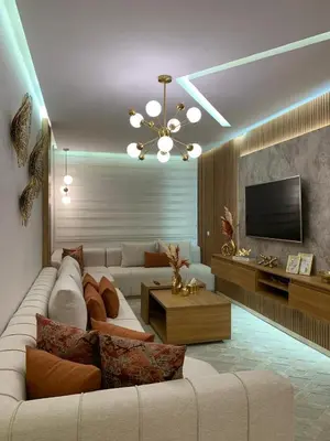 a living room with a white couch and a television at Appartement luxueux marrakech in Marrakech