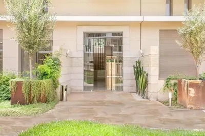 a front door of a house with trees in front at Appartement luxueux marrakech in Marrakech