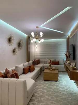 a living room with a white couch and a television at Appartement luxueux marrakech in Marrakech