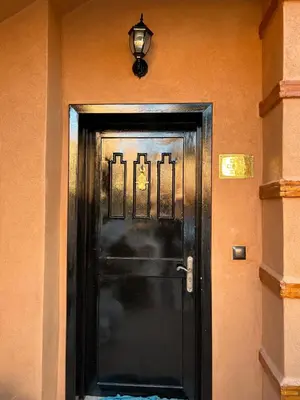 a black door in a building with a light on it at Dar Celya Sfia in Marrakech