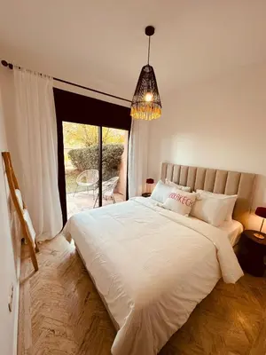 a bedroom with a large white bed and a window at Dar Celya Sfia in Marrakech