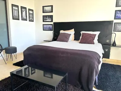 a bedroom with a large bed and a glass table at Palais Bali in Marrakech