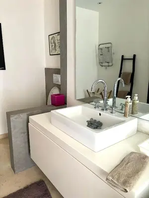 a bathroom with a white sink and a mirror at Palais Bali in Marrakech