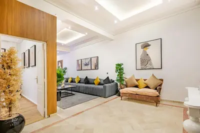 a living room with two couches and a table at Villa YOGA Guéliz Centre-Ville in Marrakech