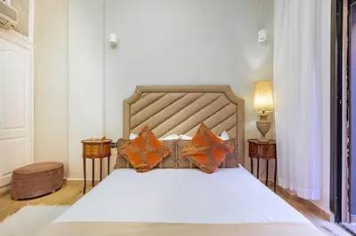 a bedroom with a large bed with orange pillows at Villa YOGA Guéliz Centre-Ville in Marrakech