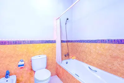 a bathroom with a toilet and a bath tub at Villa YOGA Guéliz Centre-Ville in Marrakech